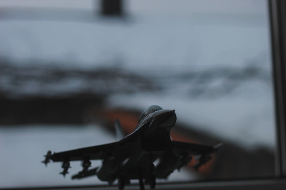 a toy airplane sitting on top of a window sill