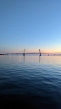 A serene bridge glowing softly at dusk symbolizing connection and transition