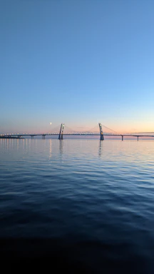 A serene bridge glowing softly at dusk symbolizing connection and transition
