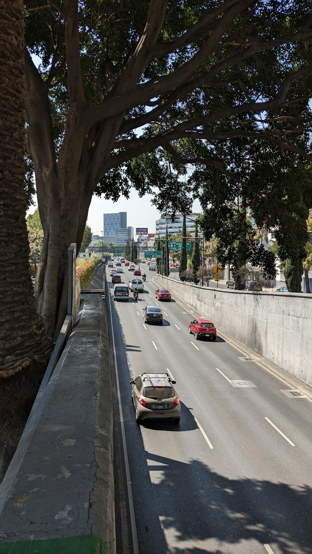 cars are driving down the street in a city