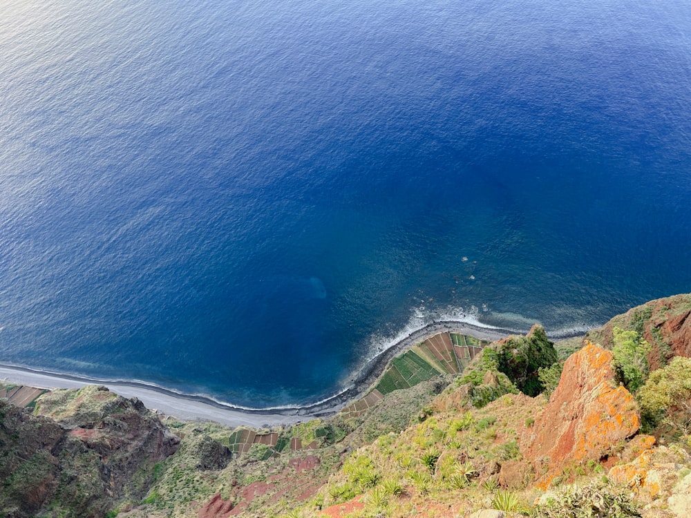 a large body of water sitting on the side of a mountain