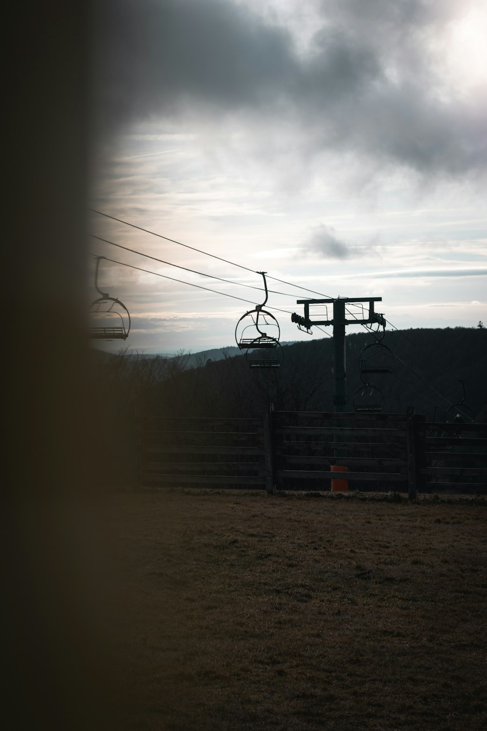 a couple of chairs sitting on top of a wooden fence