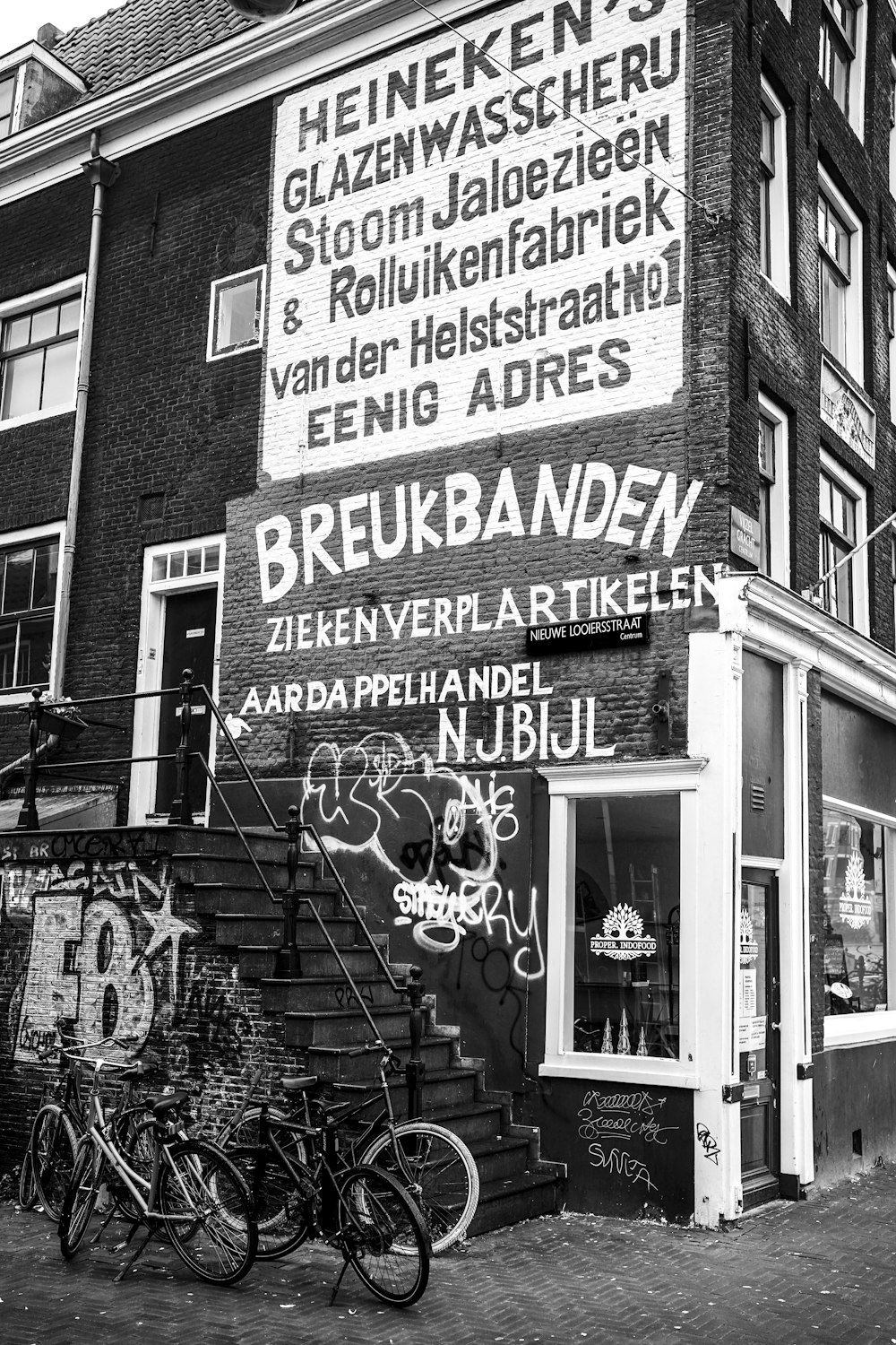 a black and white photo of a building with graffiti on it