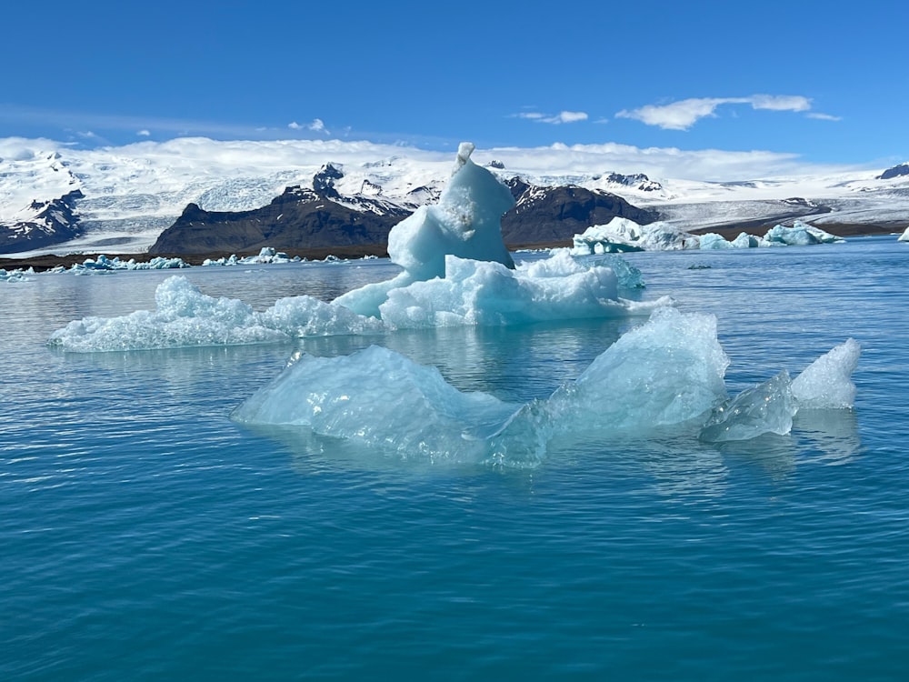 a large iceberg floating in the middle of a body of water