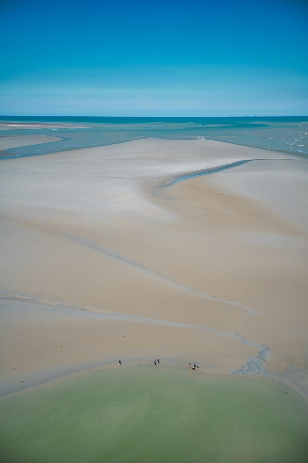 a large body of water sitting next to a sandy beach