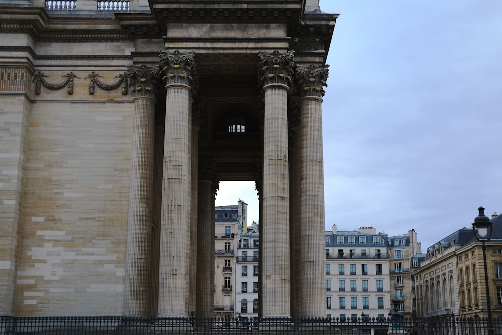 a very tall building with many pillars in front of it