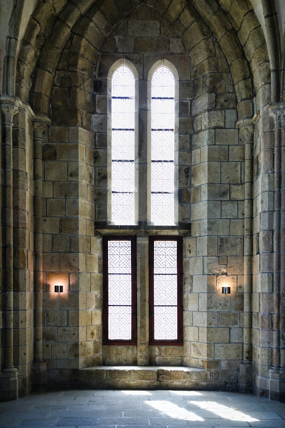 a large stone building with two large windows