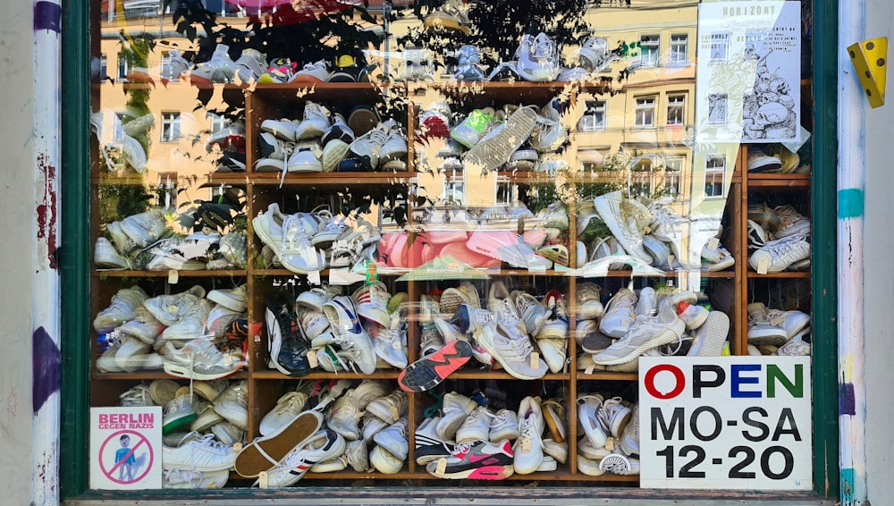 a bunch of shoes that are in a window