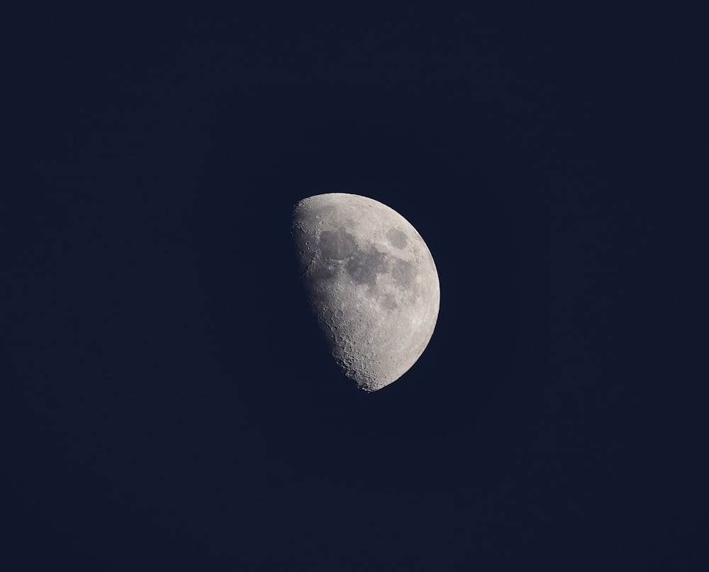 a half moon in a dark blue sky