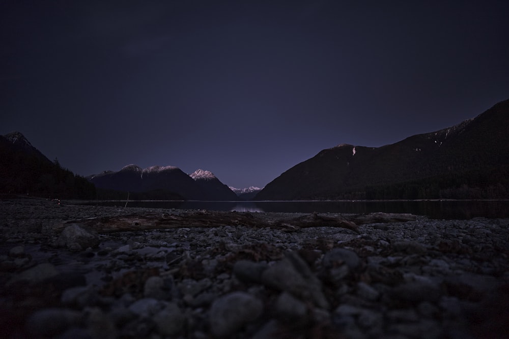a view of a lake and mountains at night
