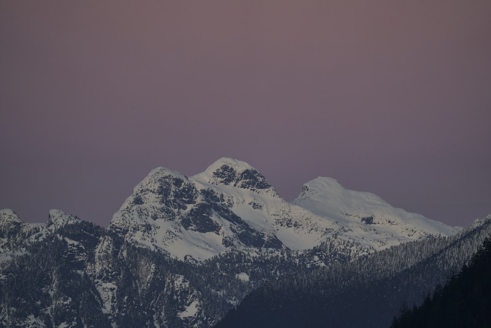 a view of a snowy mountain range at night