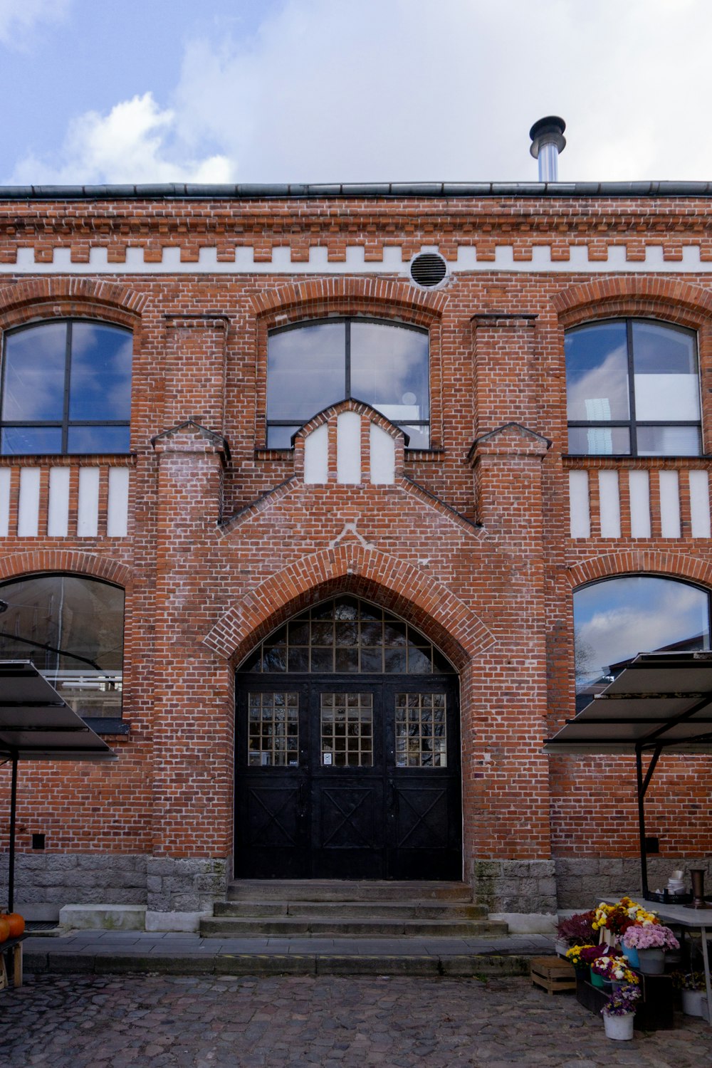 a large brick building with a black door