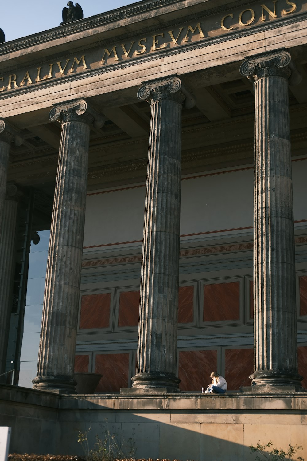 two people sitting on the steps of a building