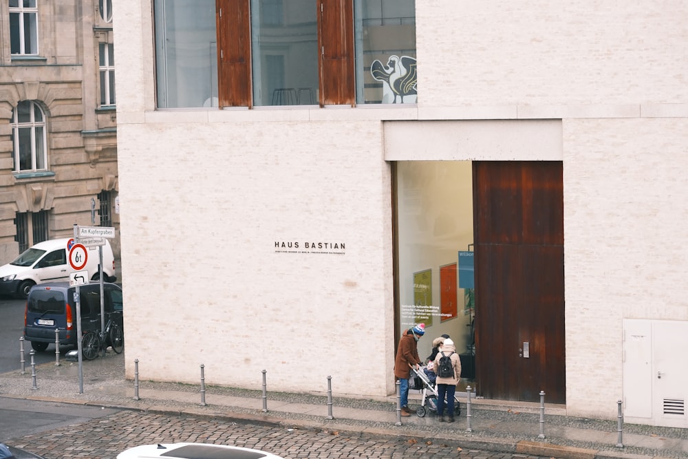 a couple of people that are standing outside of a building