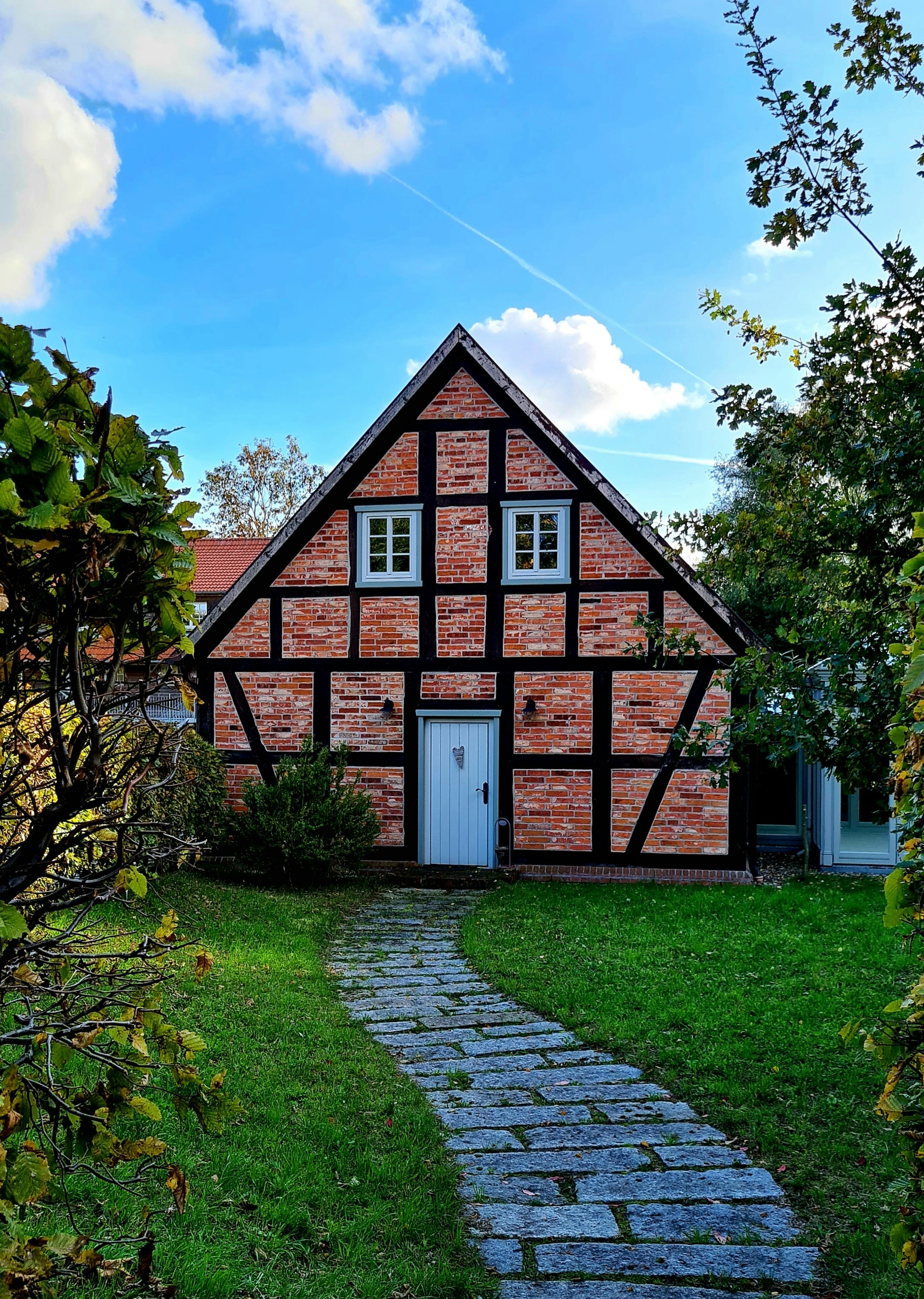 a brick house with a white door and windows