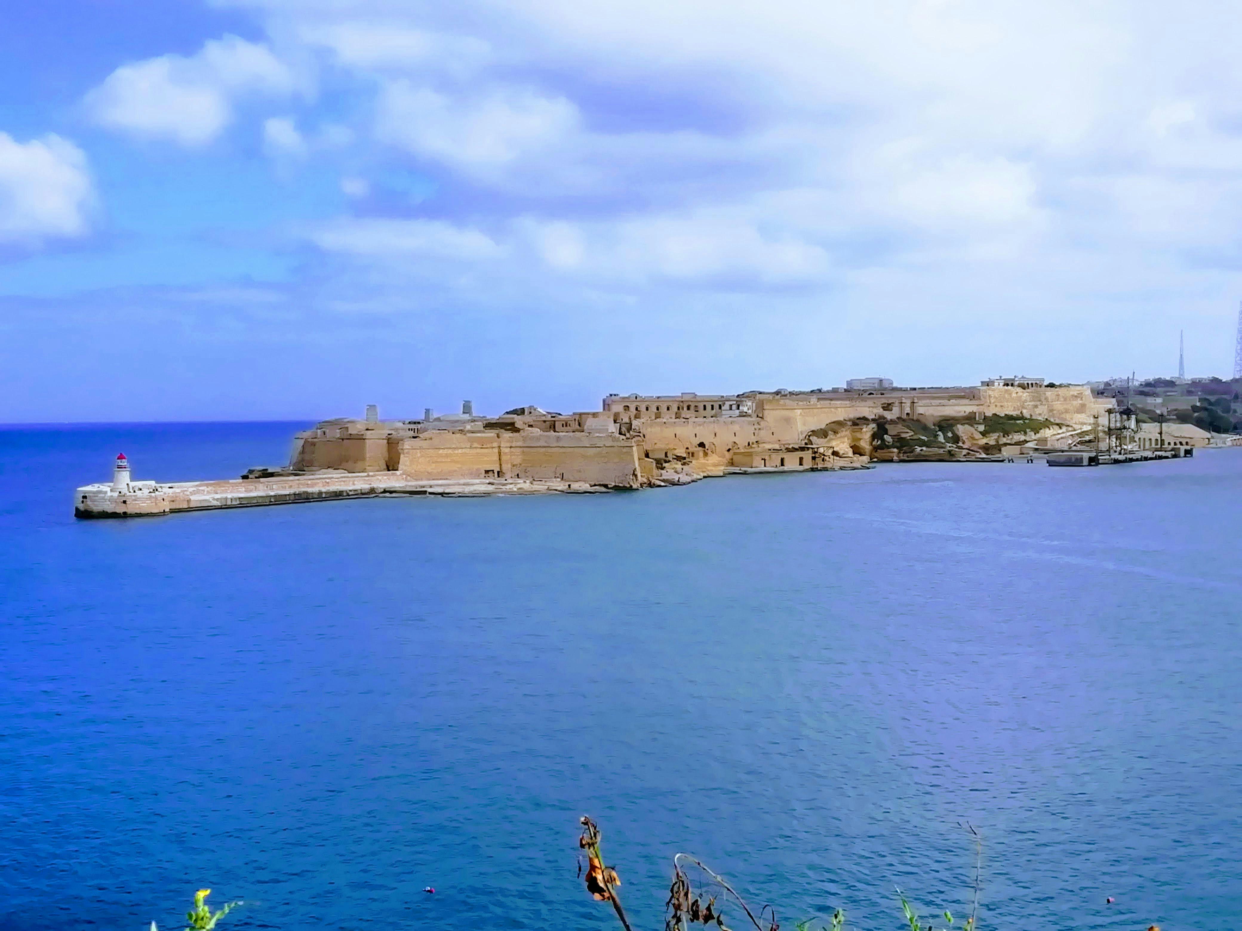 a large body of water with a castle in the background, 