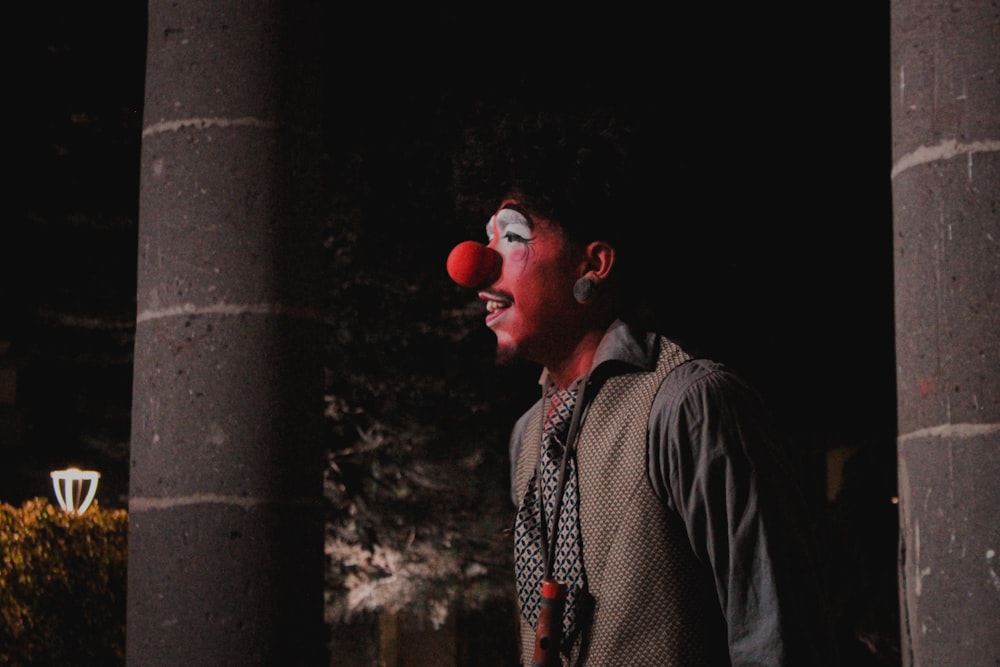a man with clown makeup and a clown nose