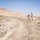 A professional taking photos of a rural land parcel with surrounding desert landscape.