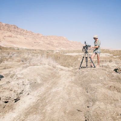 A panoramic shot of the rugged Australian outback with a hunter and trophy in the foreground.