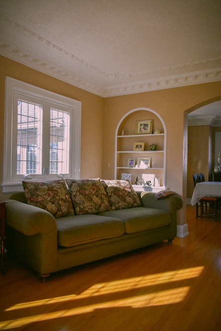 a living room with a couch and a book shelf