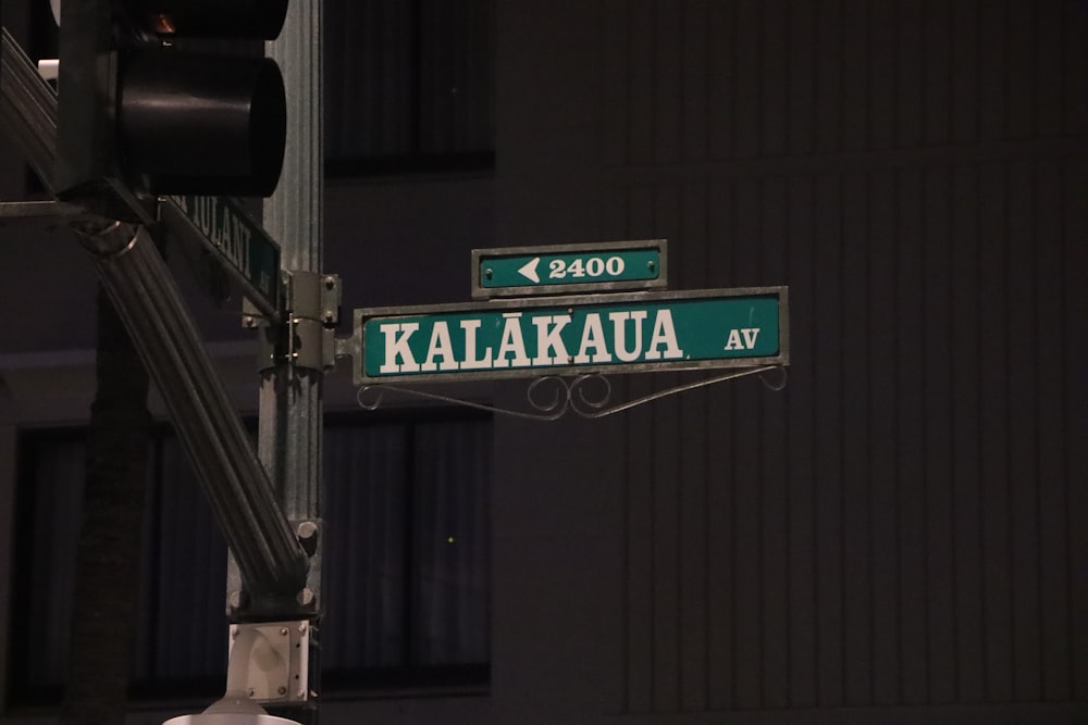 a street light with two green street signs on it