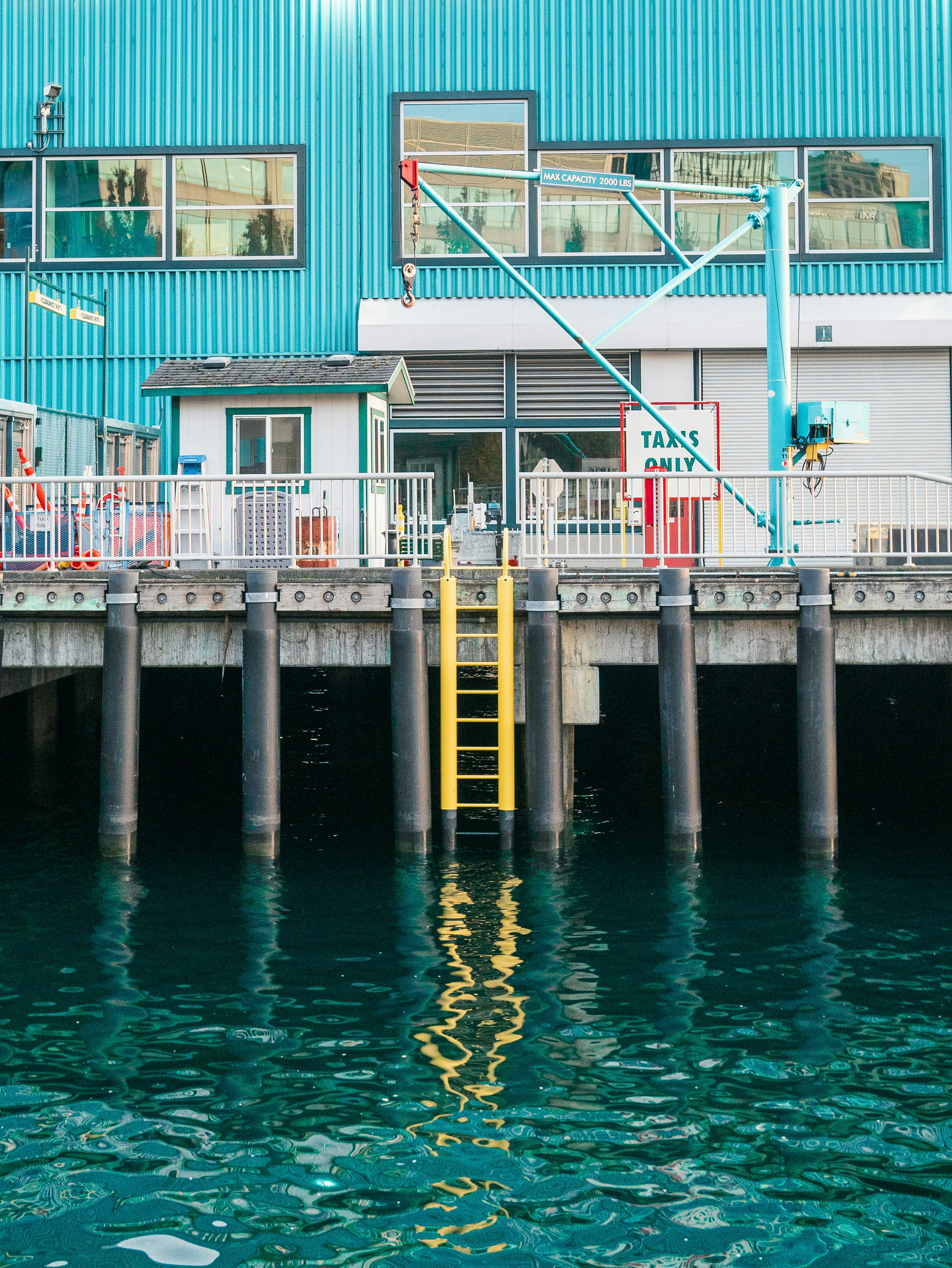 a boat dock with a blue building in the background