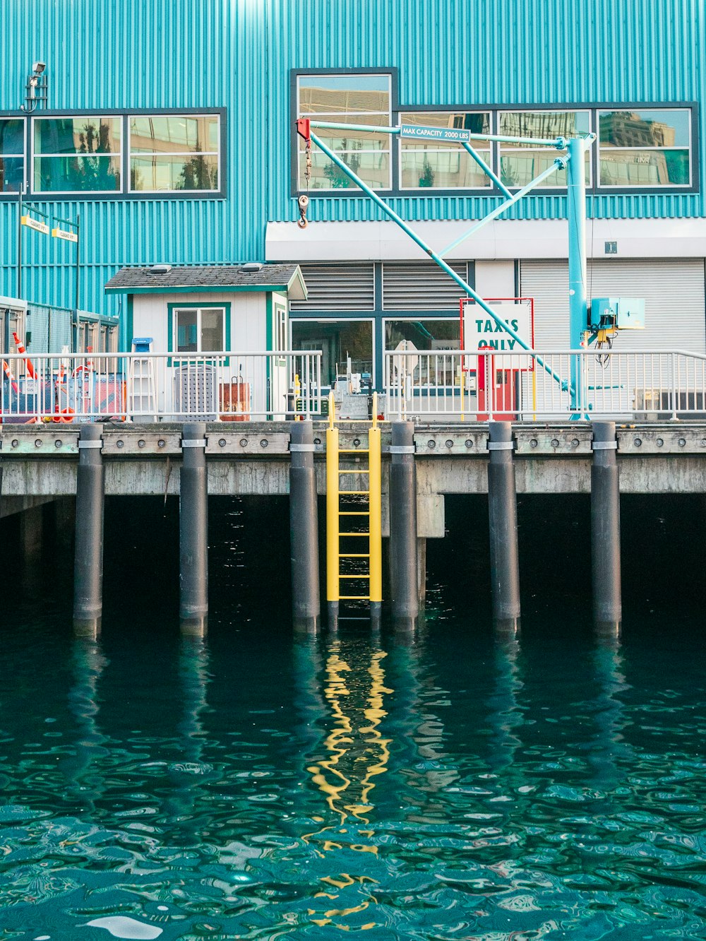 a boat dock with a blue building in the background