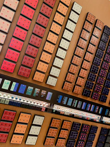 Photo of a variety of coffee capsules neatly arranged on a wooden table.