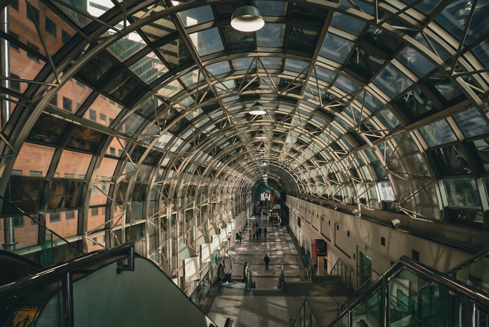 an escalator in a building with many windows