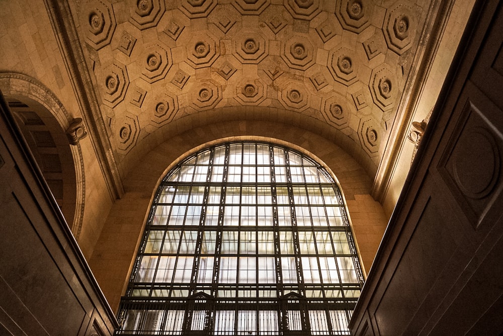 the ceiling of a train station with a large window