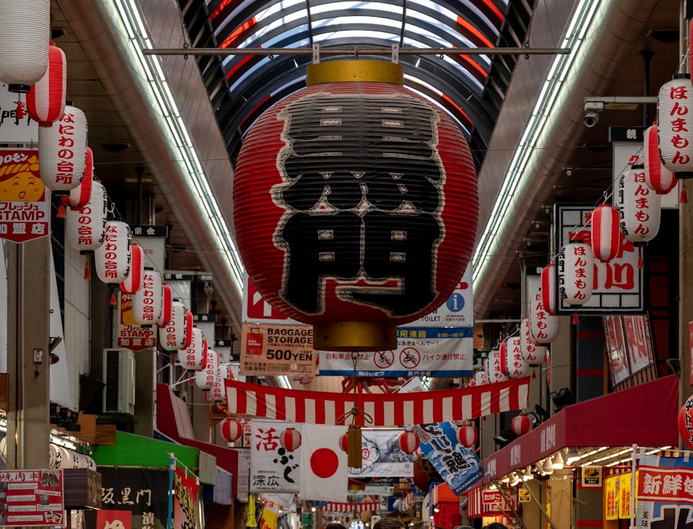 a shopping mall with a lot of signs hanging from the ceiling