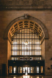A bright entrance featuring a large glass door framed by elegant metalwork.