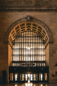 Wide shot of a grand entrance featuring glass panels and elegant framing.