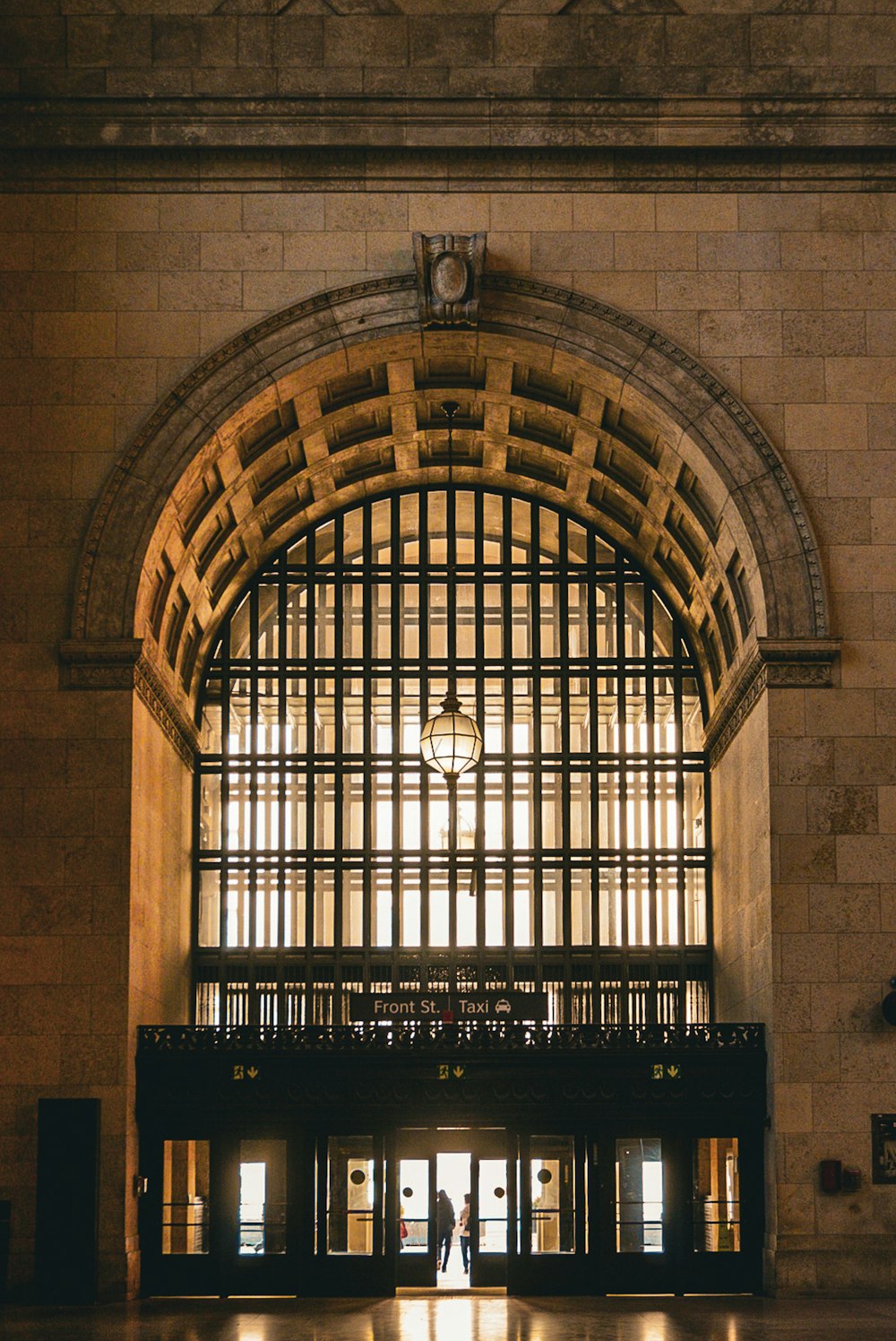 a bride and groom are standing in the lobby of a train station