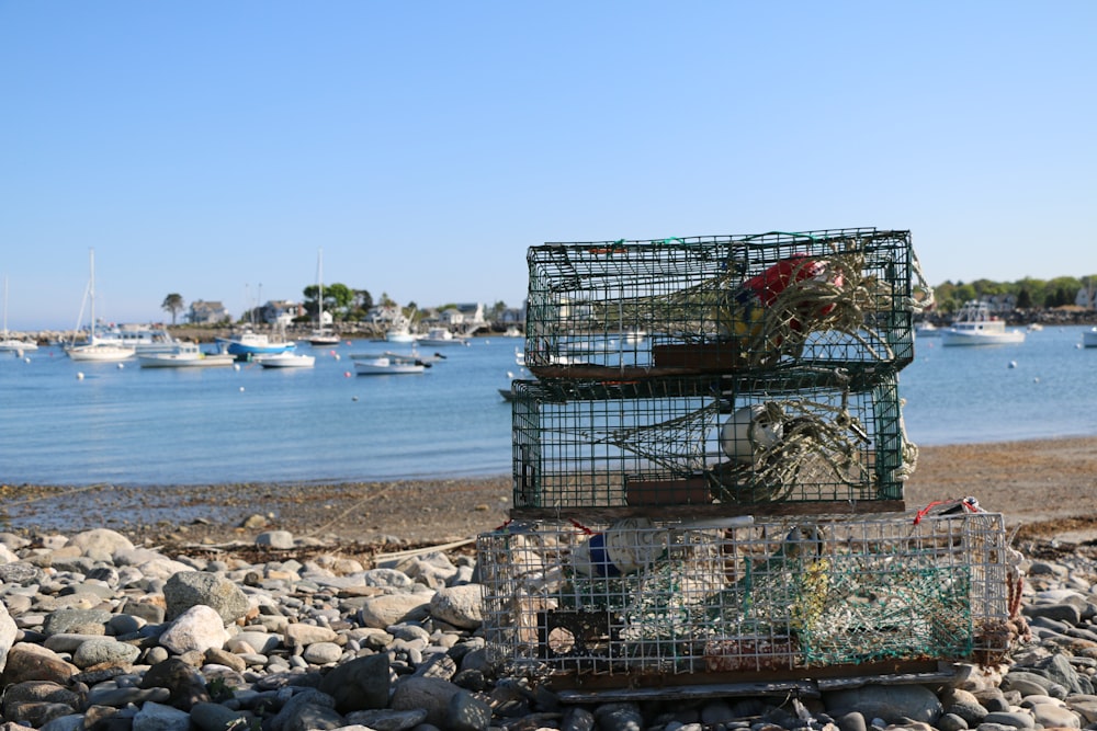 a couple of cages sitting on top of a pile of rocks