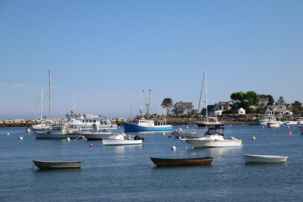 a group of boats floating on top of a body of water