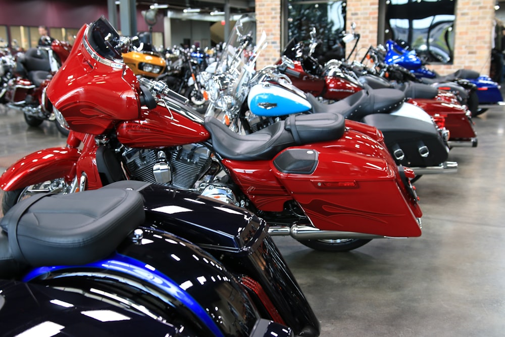 a row of motorcycles parked inside of a building
