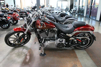 A bright, inviting showroom filled with shiny motorcycles under warm lighting.