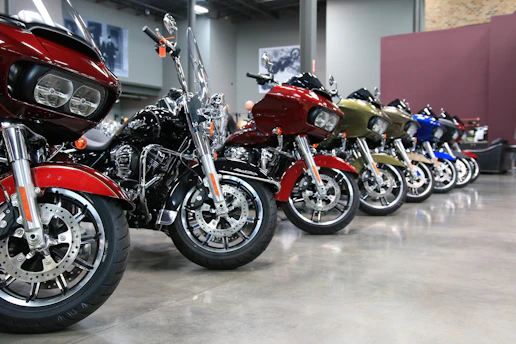 Rows of motorcycles neatly stored on tall, organized shelves inside a clean, well-lit warehouse.