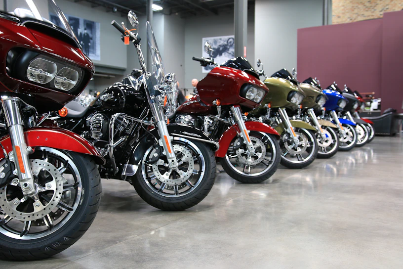 A sleek, modern warehouse interior with motorcycles neatly lined up under soft, elegant lighting.
