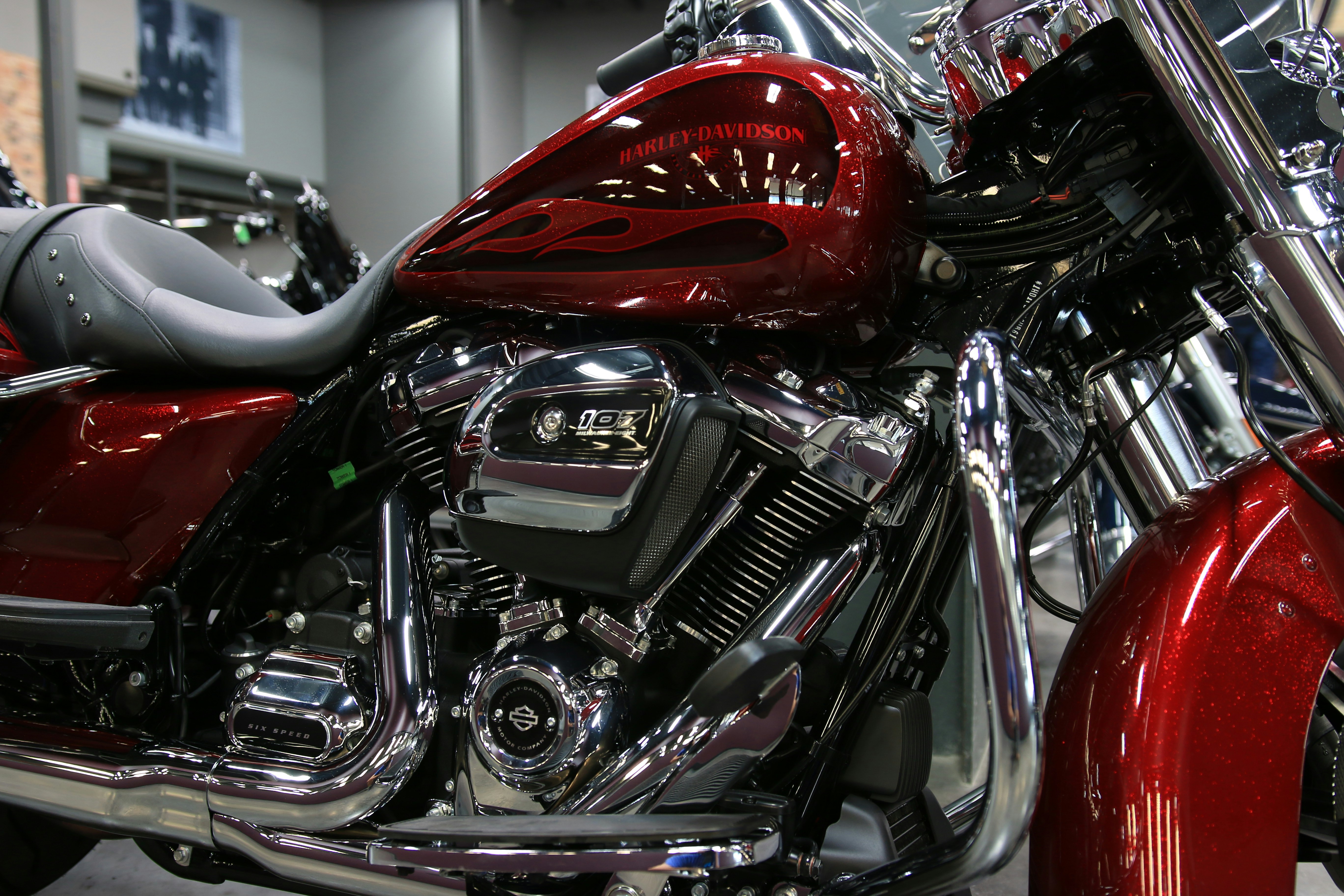 a red motorcycle is parked in a showroom