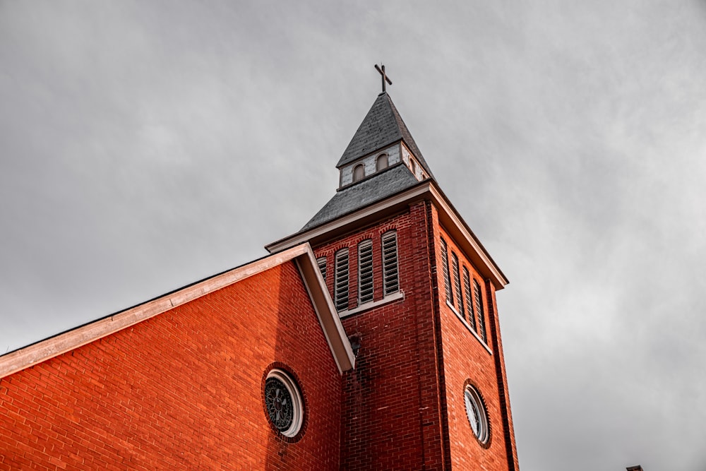 a red brick building with a steeple and a clock