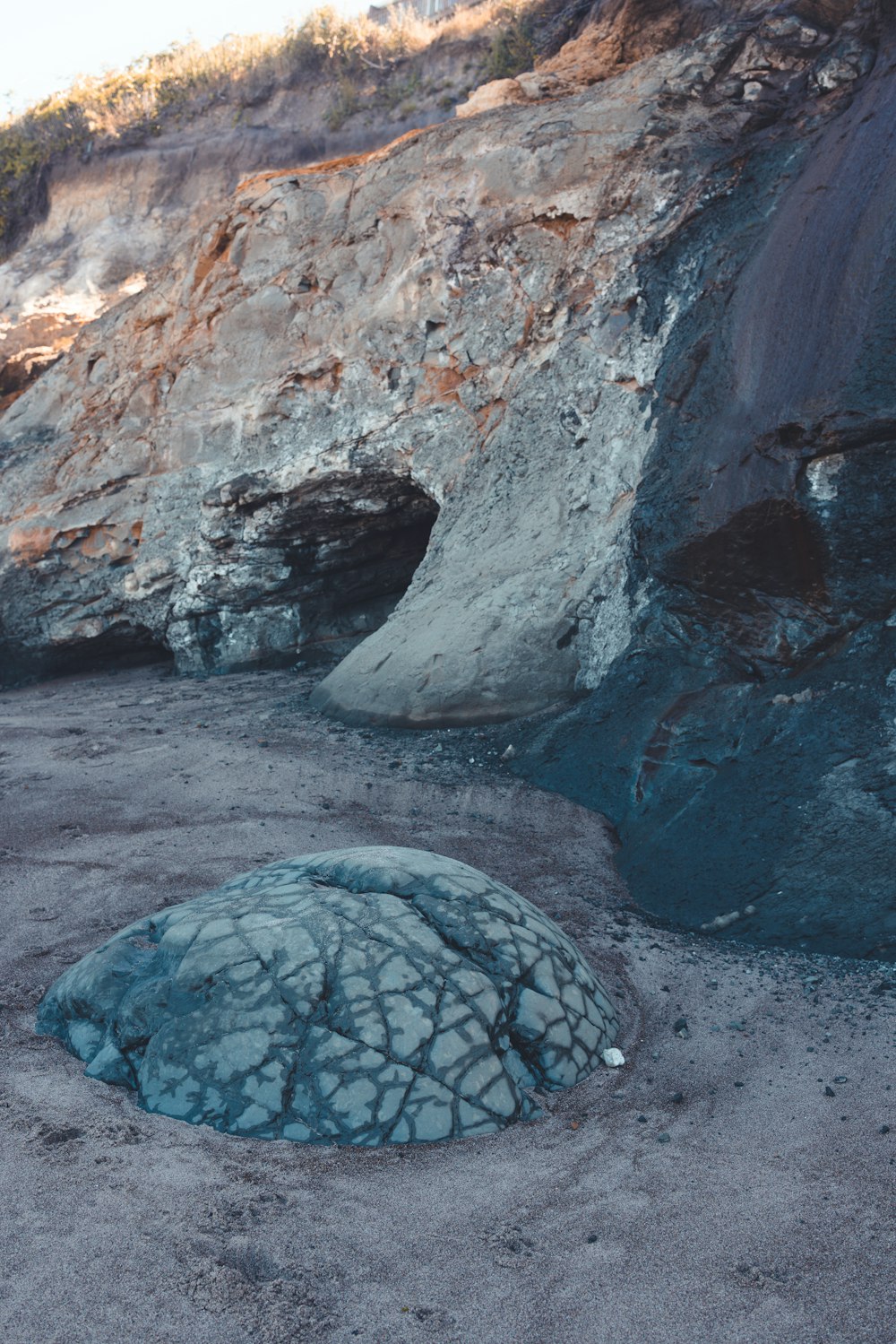 a rock formation with a blue substance in the middle of it