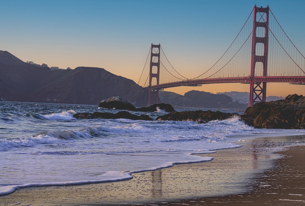 a view of the golden gate bridge from the beach