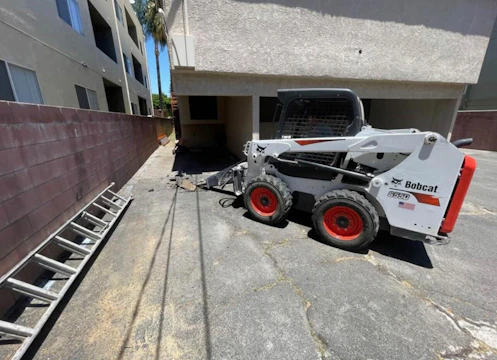 A sleek Bobcat skid-steer loader maneuvering on a construction site.