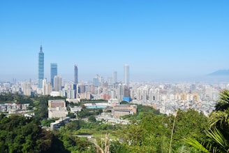A vibrant aerial view of Prestige City Mulund showcasing its sprawling residential towers against a clear blue sky.