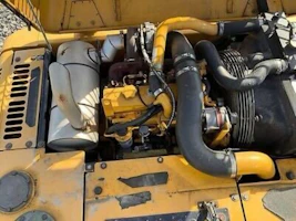 Close-up of a powerful stationary engine with metallic details and yellow accents