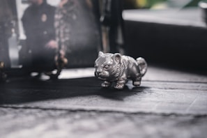 An artistic shot capturing a subtle rat figurine placed thoughtfully, reflecting Taras's zodiac sign and personality.