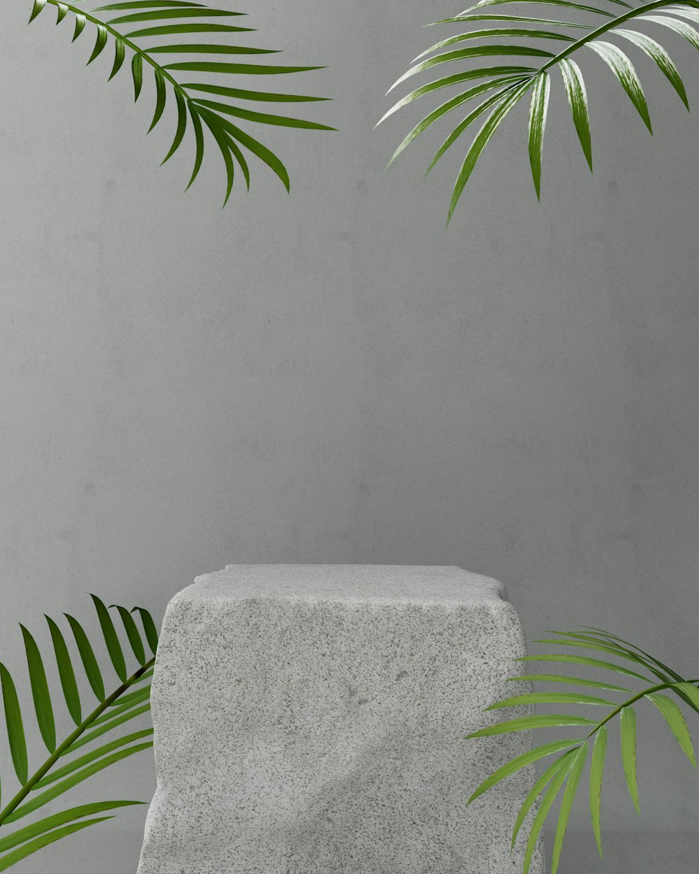 a concrete block with a green plant on top of it