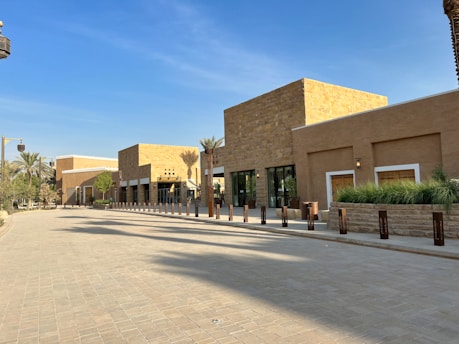 A vibrant street view of Jessheim showcasing modern buildings and green spaces under a clear blue sky.